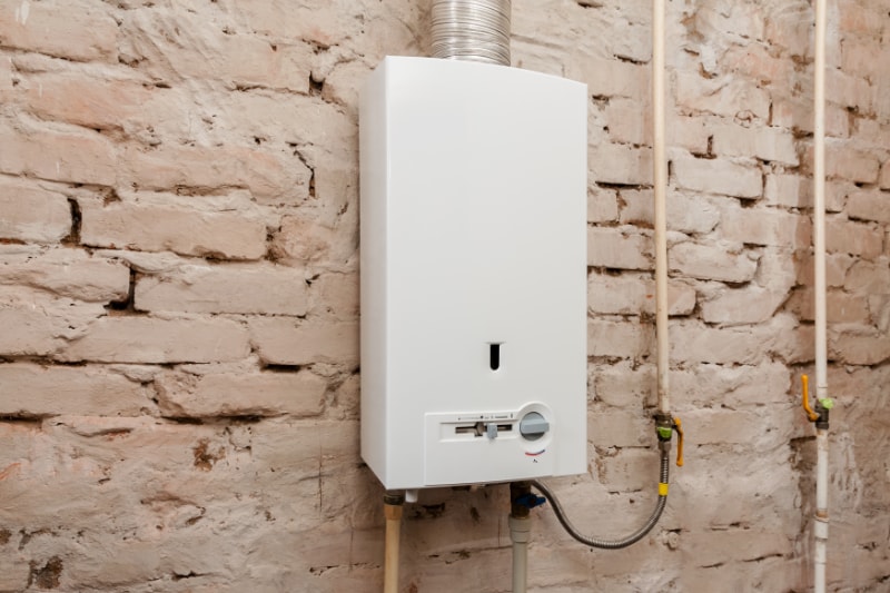 gas boiler with brick wall behind it