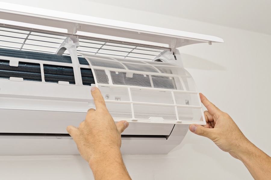 Changing the filter in the air conditioner. The concept of safe and healthy housing